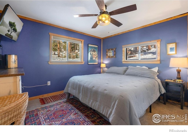 carpeted bedroom with crown molding and ceiling fan