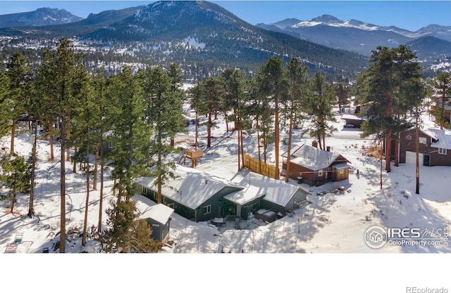 snowy aerial view with a mountain view