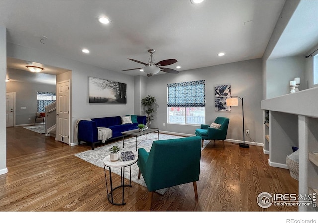 living room featuring ceiling fan and hardwood / wood-style floors