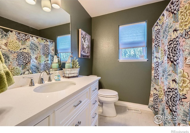 bathroom featuring tile patterned floors, vanity, and toilet