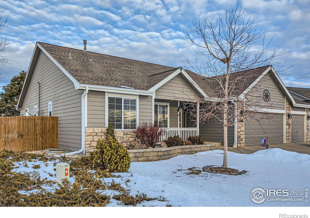 ranch-style house featuring a porch and a garage