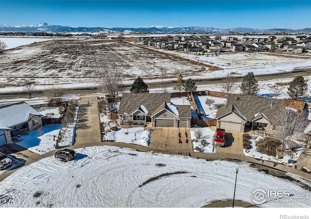 snowy aerial view featuring a mountain view