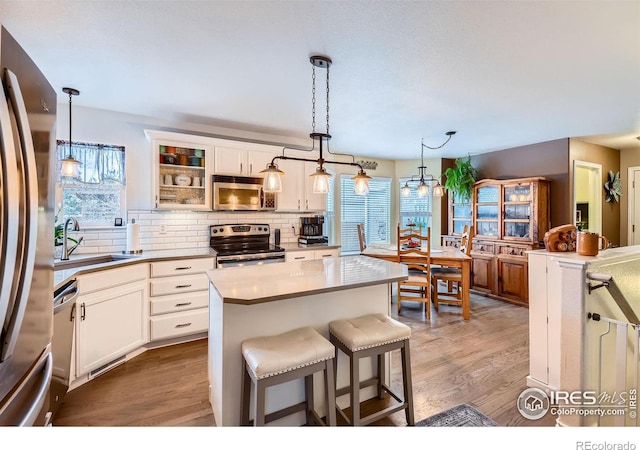 kitchen featuring stainless steel appliances, sink, and white cabinets