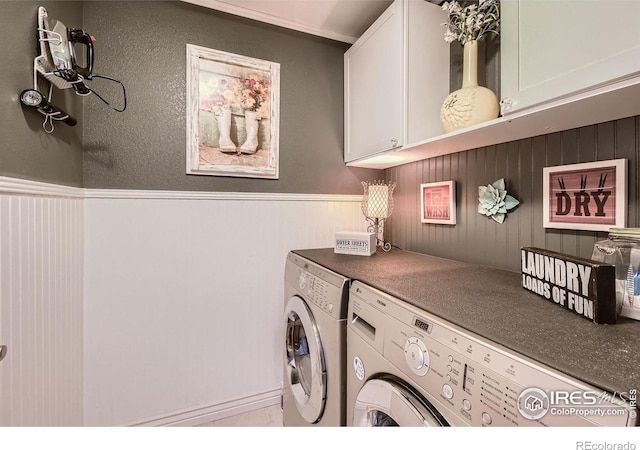 laundry area with cabinets and washer and clothes dryer