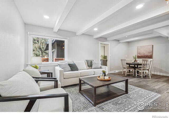 living room featuring hardwood / wood-style floors and beamed ceiling