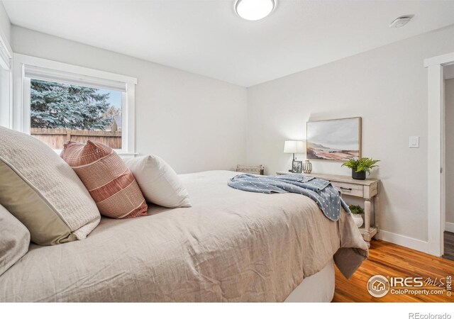 bedroom with wood-type flooring