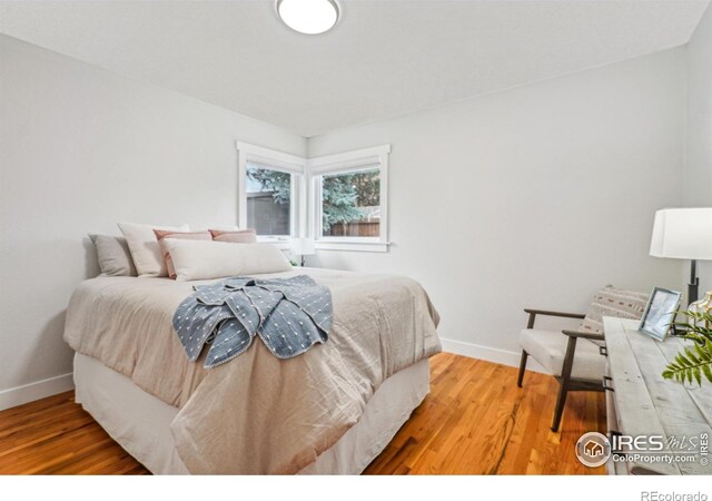 bedroom with hardwood / wood-style flooring