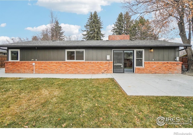 rear view of house featuring a yard and a patio