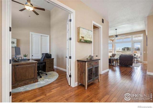 office space featuring wood-type flooring and ceiling fan