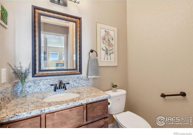 bathroom with vanity and toilet