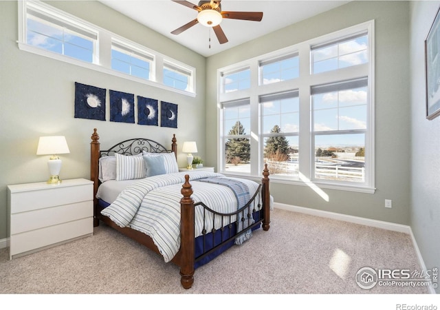 bedroom featuring ceiling fan and light carpet