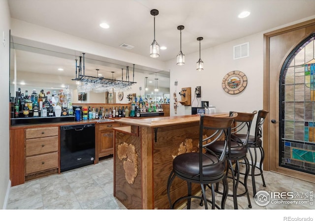 bar with dishwasher, wood counters, and decorative light fixtures