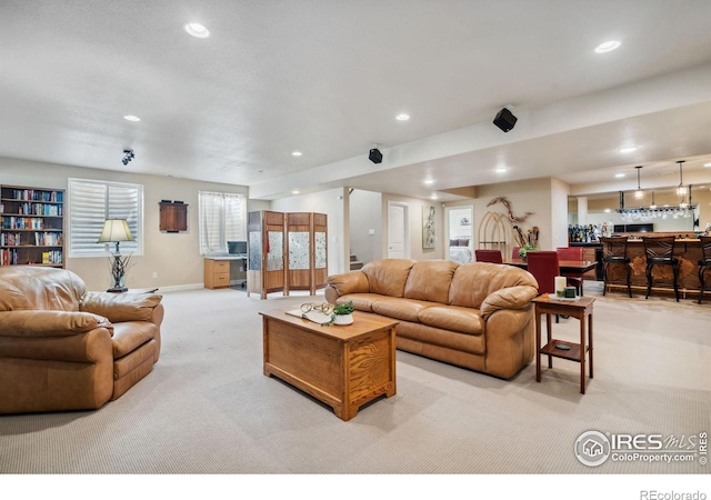 living room with light carpet and indoor bar