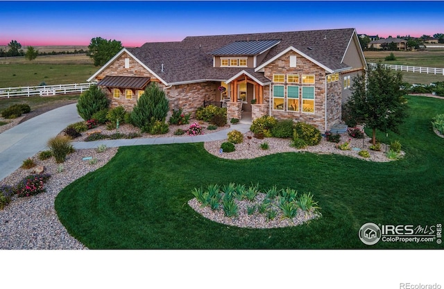 craftsman-style house featuring a lawn