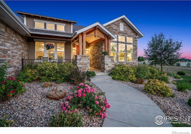 exterior entry at dusk with a porch