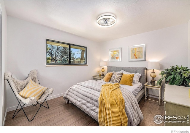 bedroom with wood finished floors and baseboards