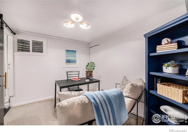 carpeted office space featuring a barn door, baseboards, and a textured ceiling