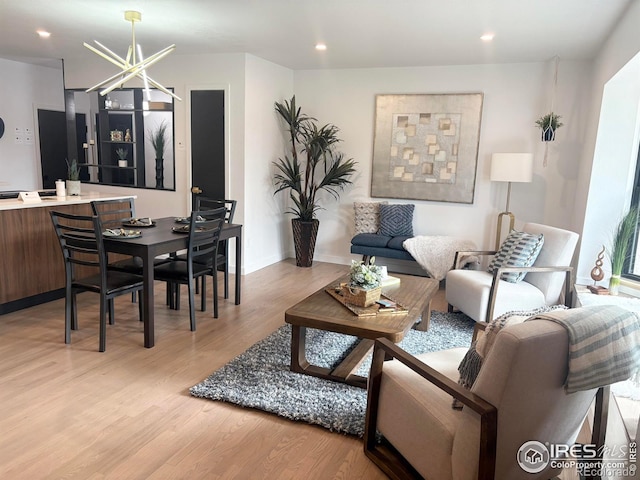 living room featuring recessed lighting, baseboards, and light wood-style floors