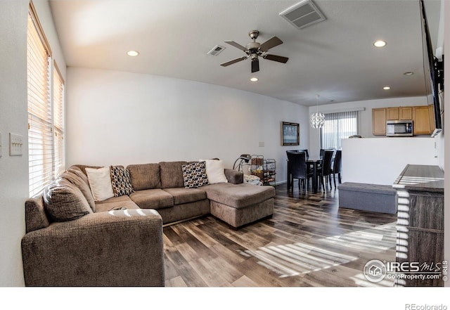 living room with dark hardwood / wood-style floors and ceiling fan