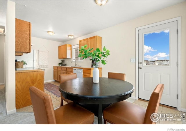 dining room featuring a wealth of natural light, sink, and light tile patterned floors