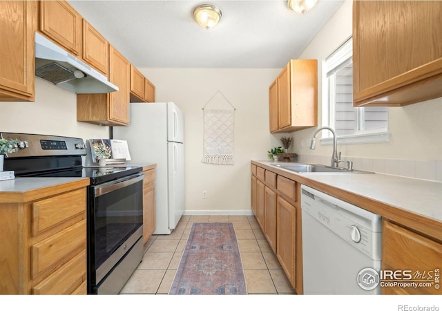 kitchen featuring dishwasher, sink, stainless steel range with electric cooktop, and light tile patterned floors