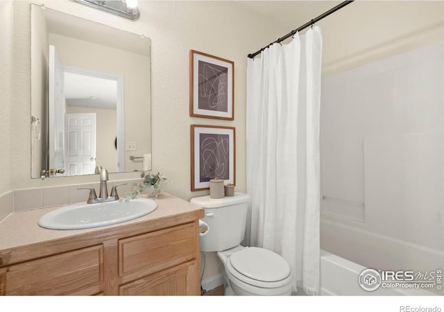 full bathroom with vanity, shower / tub combo with curtain, and toilet