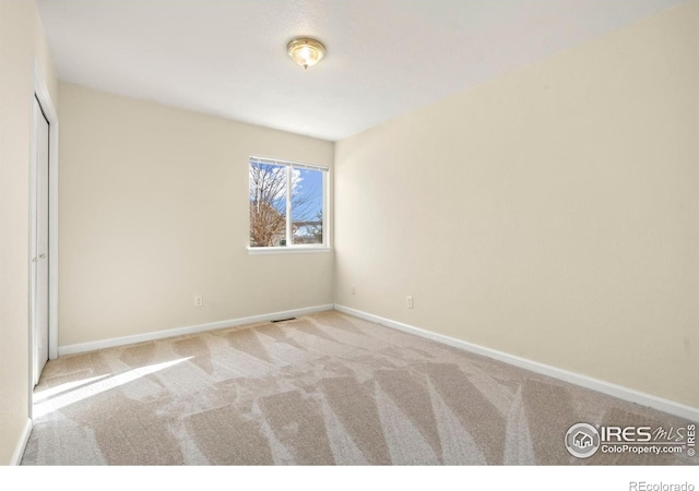 empty room with light colored carpet