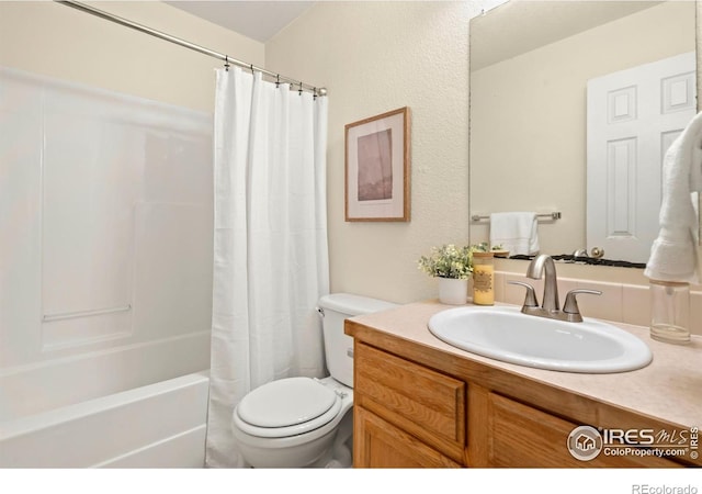 full bathroom featuring shower / bath combination with curtain, vanity, and toilet