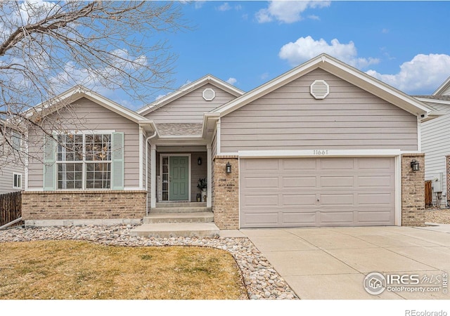 view of front of house with a garage and a front lawn