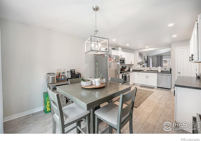 dining room with sink and an inviting chandelier