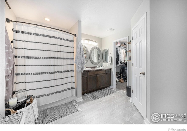 bathroom featuring vanity and a shower with shower curtain