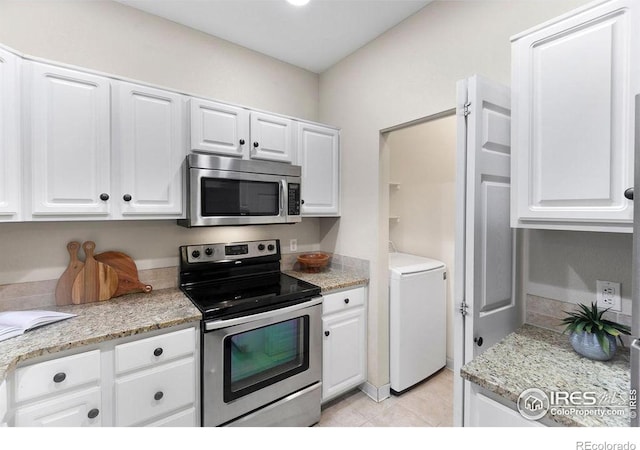 kitchen featuring white cabinetry, stainless steel appliances, washer / clothes dryer, and light stone counters