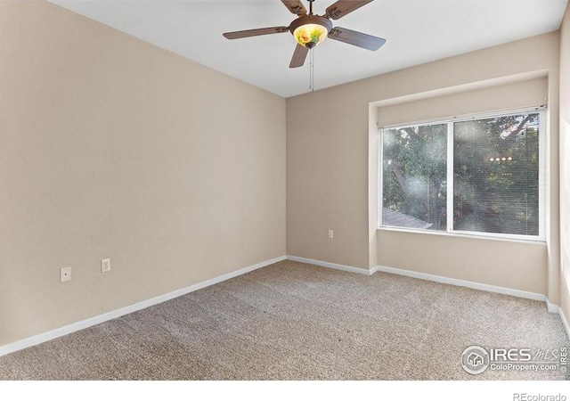 empty room featuring ceiling fan and carpet