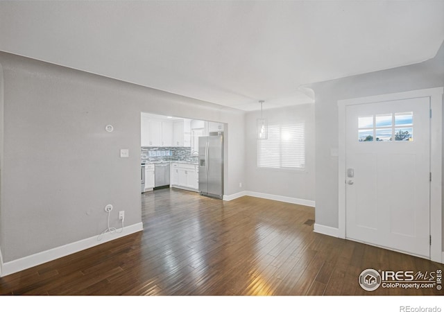 unfurnished living room with dark hardwood / wood-style flooring