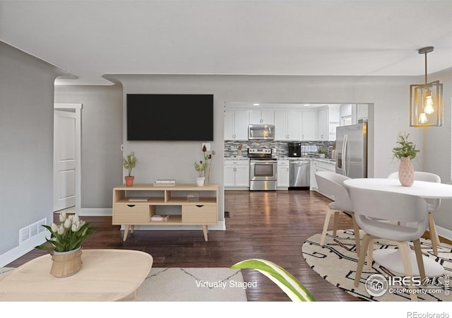 living room with dark hardwood / wood-style flooring