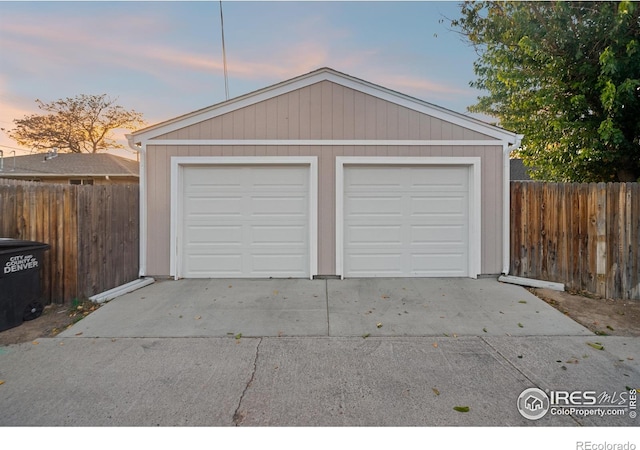 view of garage at dusk