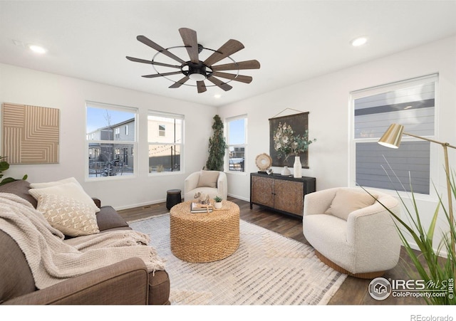 living room with dark hardwood / wood-style floors and ceiling fan