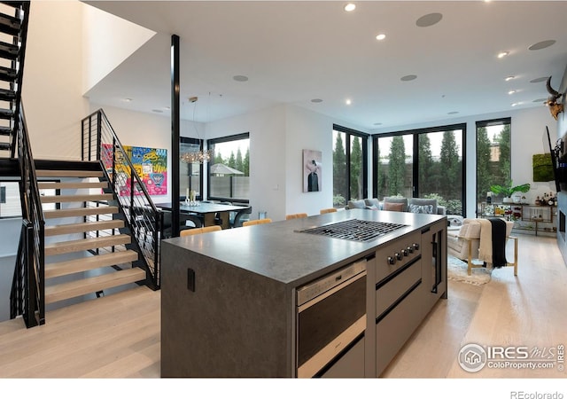 kitchen featuring pendant lighting, a center island, and light wood-type flooring