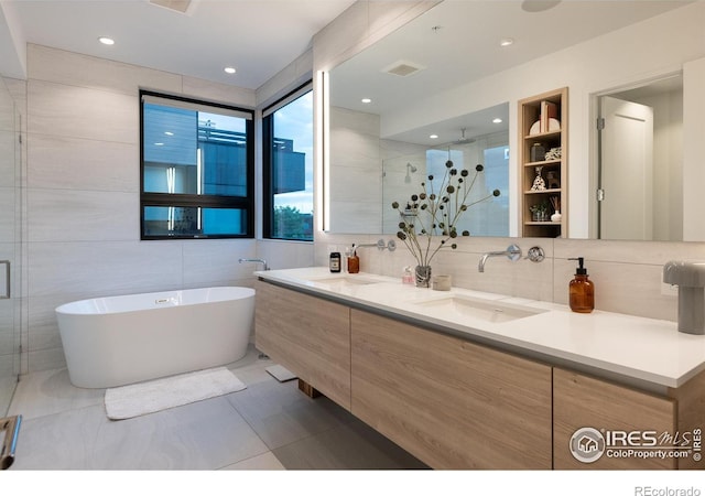 bathroom featuring vanity, shower with separate bathtub, and tile walls