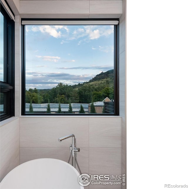 bathroom featuring a tub to relax in