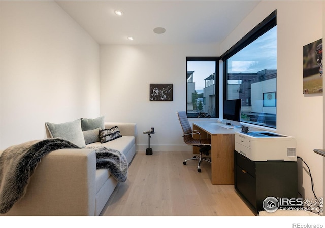 office area with light hardwood / wood-style floors