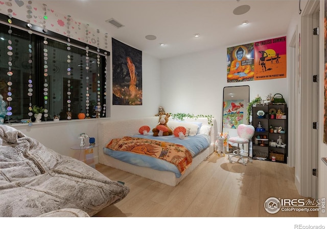 bedroom with wood-type flooring