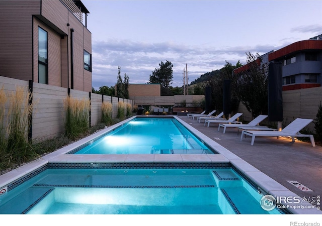 view of pool at dusk