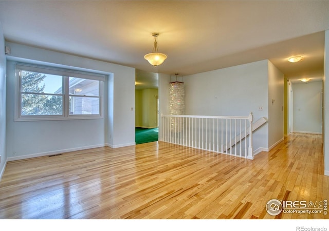 spare room with light hardwood / wood-style floors