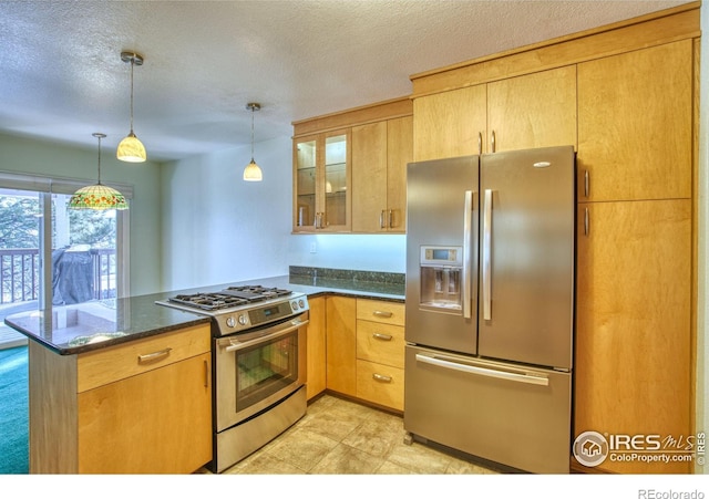 kitchen with hanging light fixtures, dark stone counters, a textured ceiling, kitchen peninsula, and stainless steel appliances