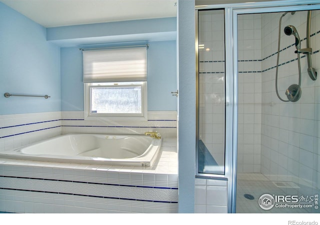 bathroom featuring separate shower and tub