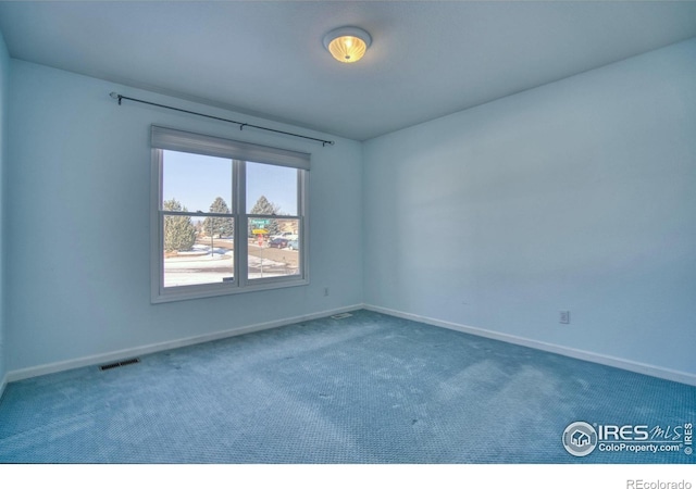 empty room featuring dark colored carpet