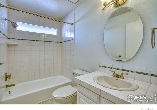 full bathroom with tiled shower / bath combo, vanity, and toilet