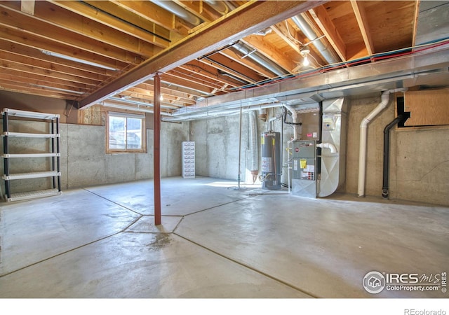 basement featuring gas water heater and heating unit