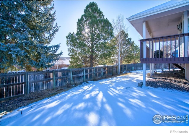 yard covered in snow featuring a patio